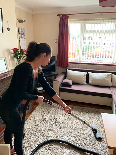 photo of a cleaner who do a hoovering