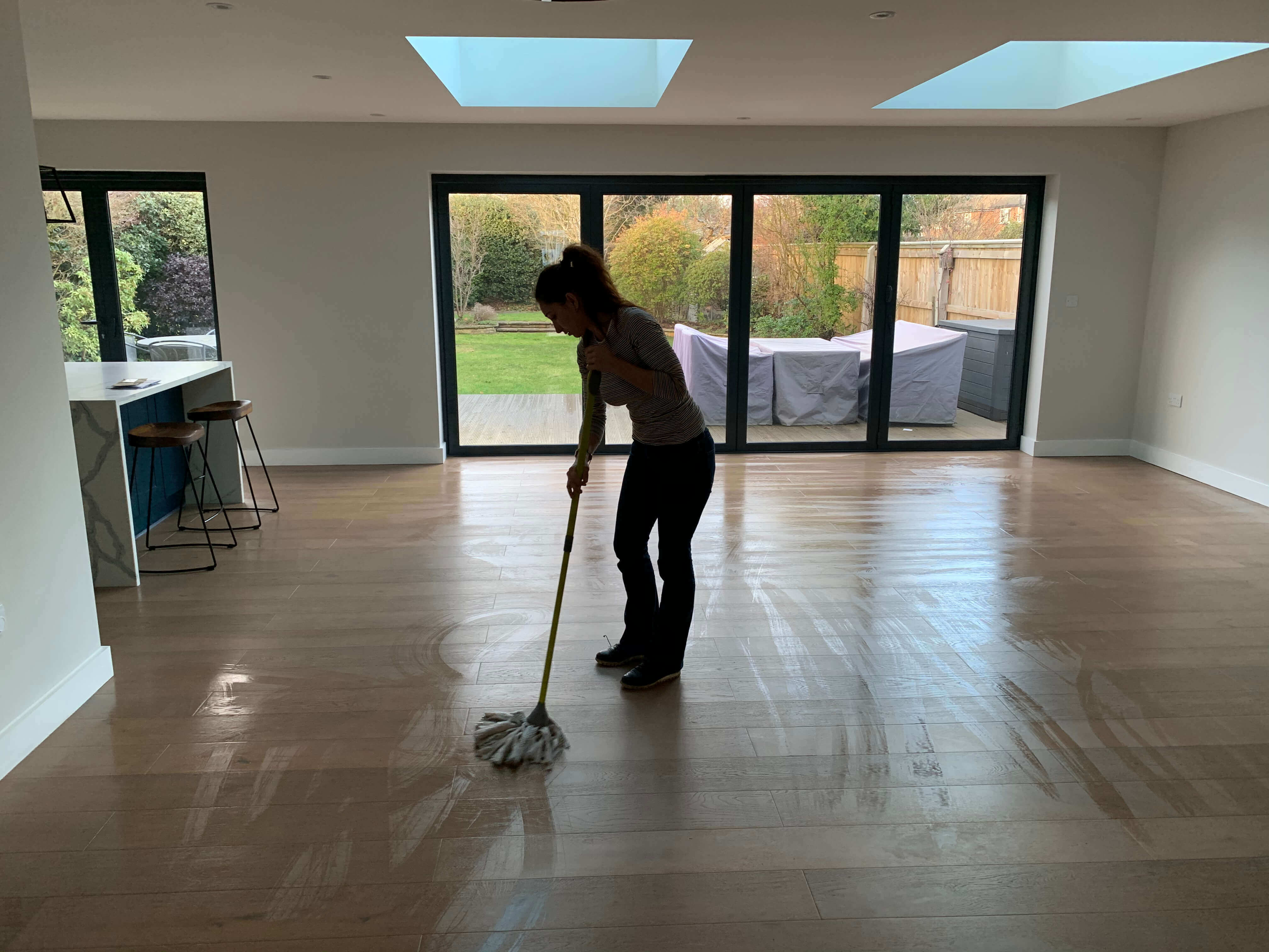 lady cleaner mopping a floor after tenancy clean is esher