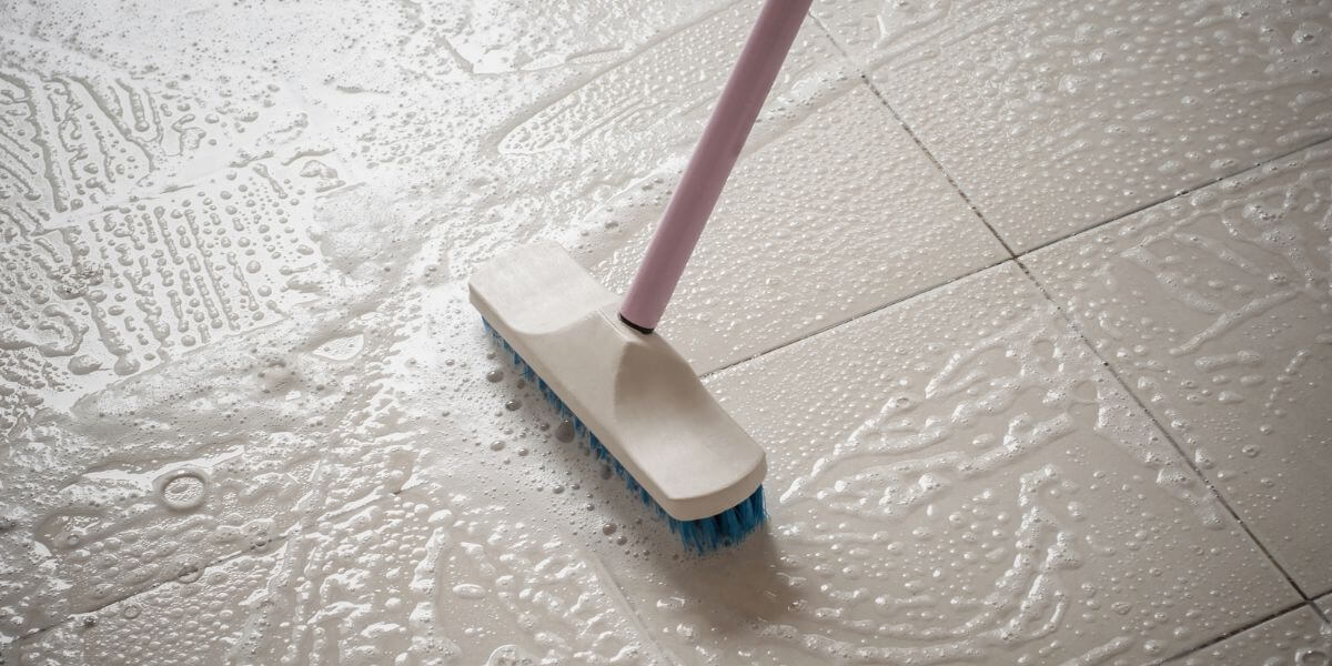 brush with water on floor during cleaning service