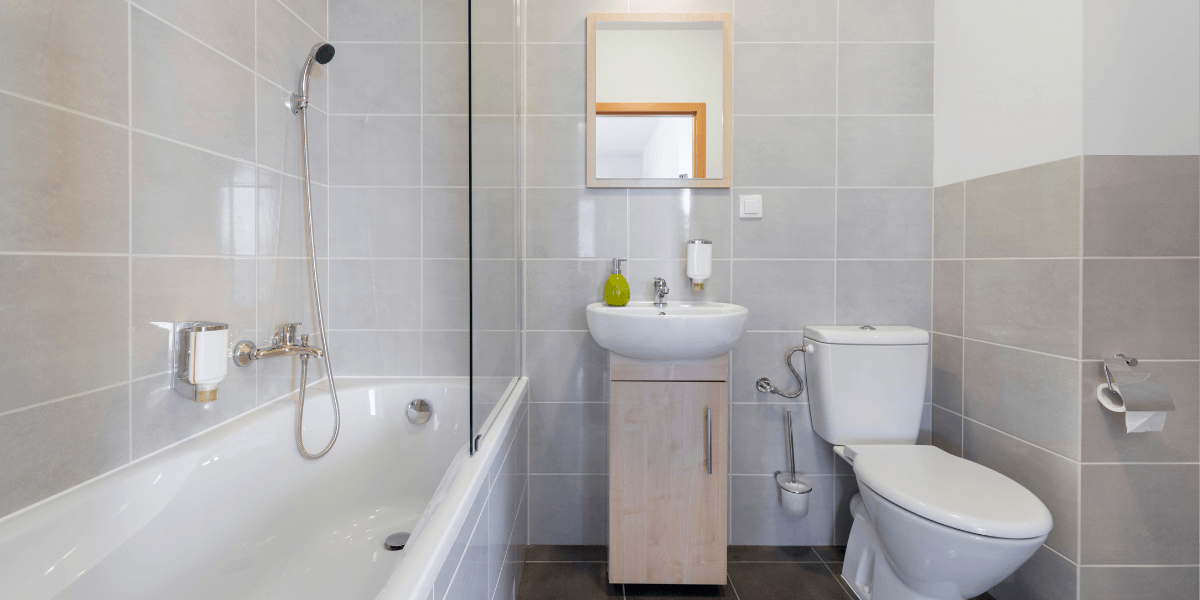 Sparkling clean bathroom with shining surfaces and fixtures, perfectly organized towels and accessories, under bright, natural light