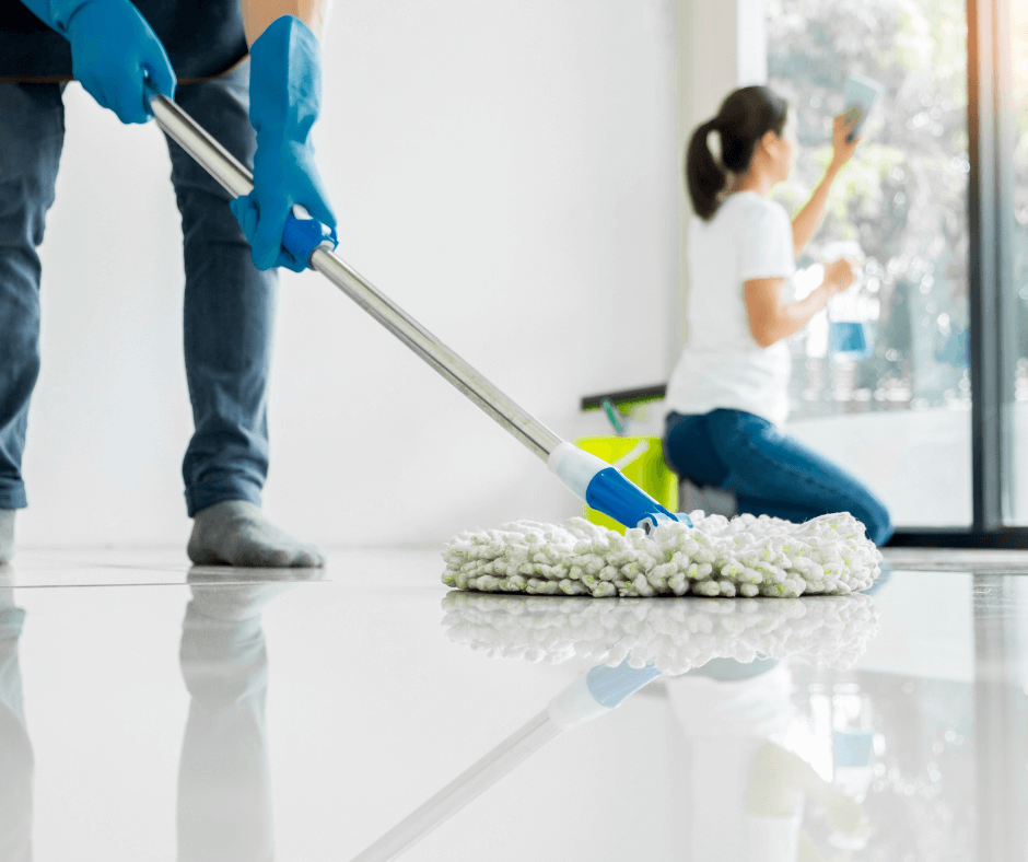 Two professional cleaners performing end of tenancy cleaning in a London rental property